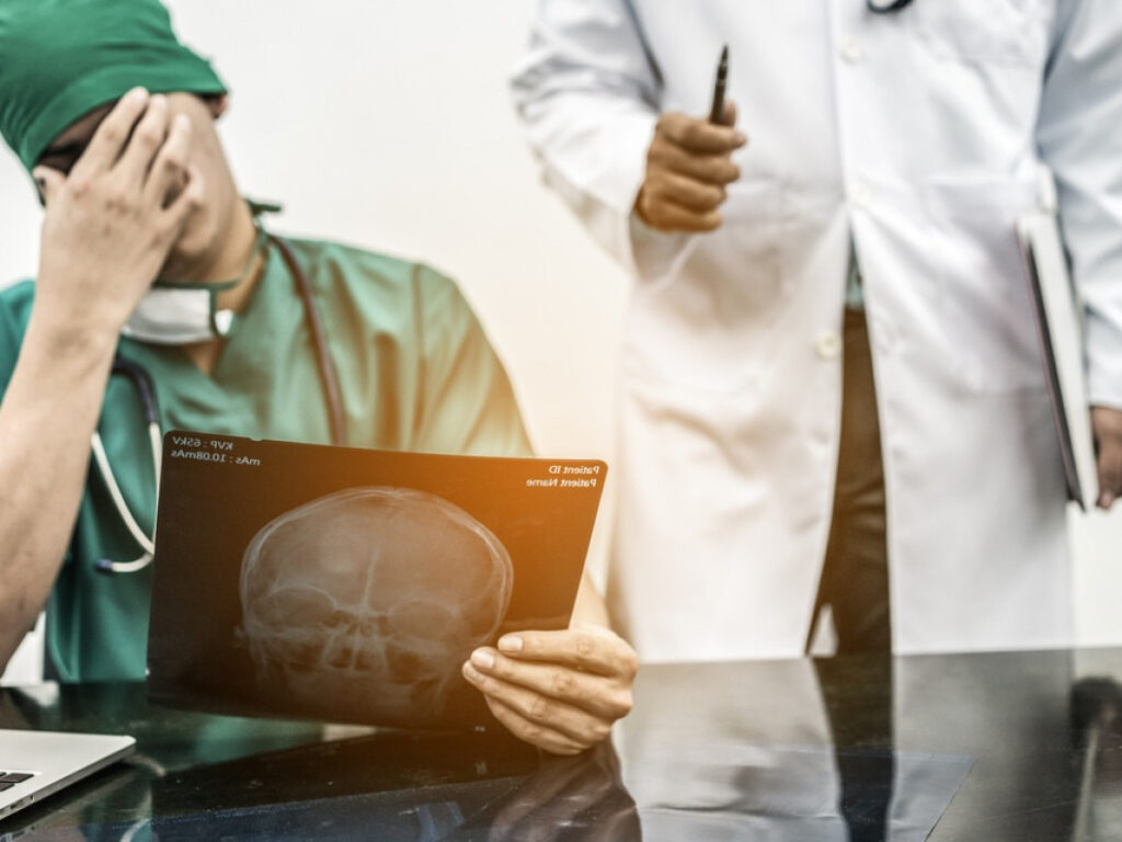 doctor looking at x-ray of a skull